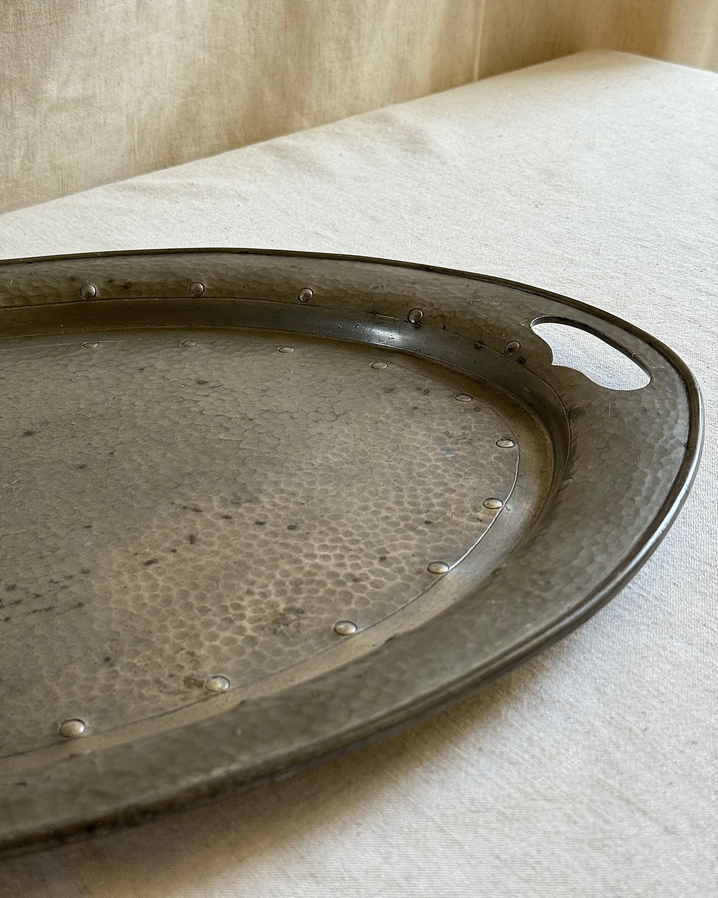 Detailed edge shot highlighting the polished handle cut-out of the pewter tray