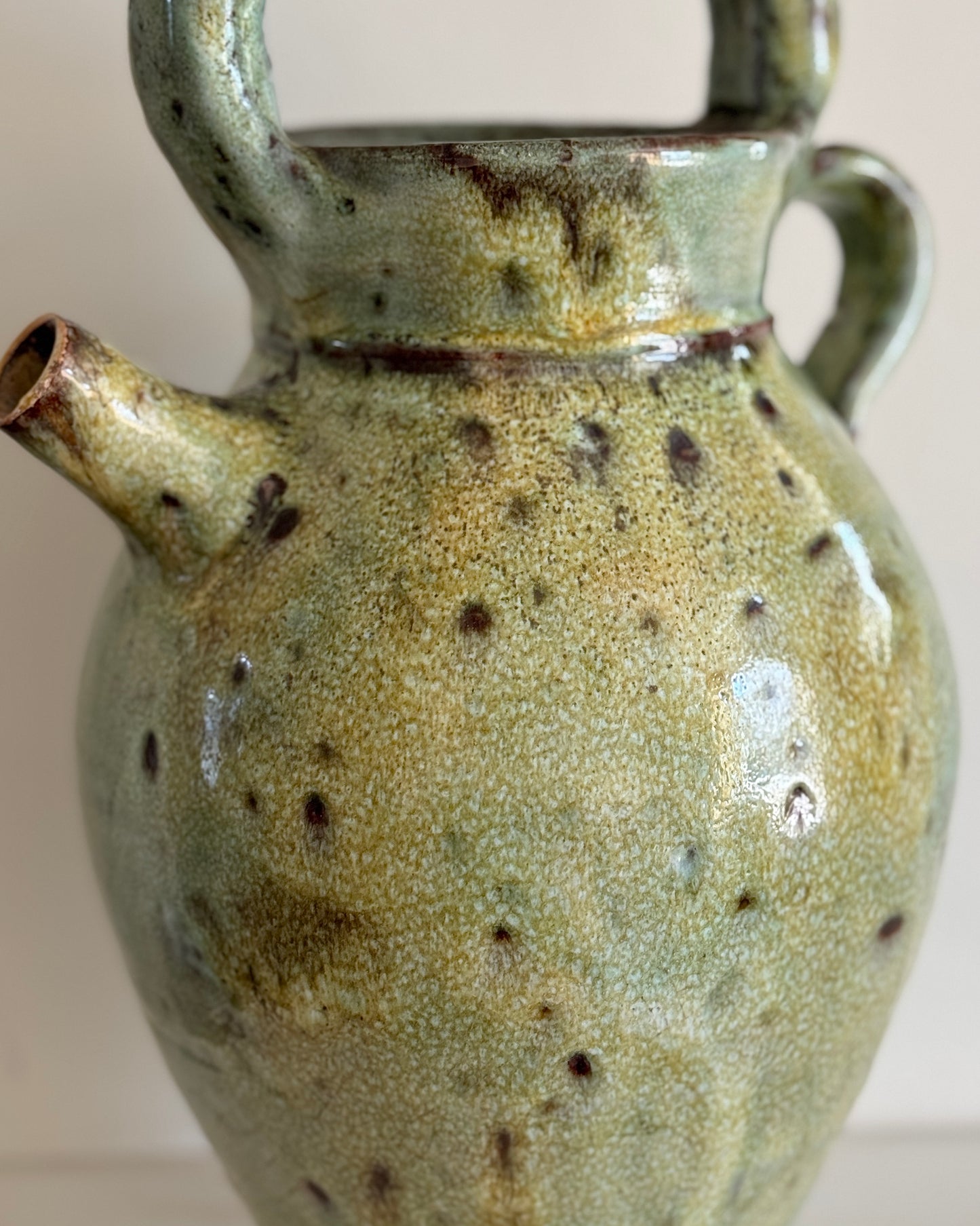 A large glazed ceramic vessel with a mottled two-tone green finish, made in South of France circa 19th Century. Signed Vallauris. The vessel features a large rounded handle on top, a smaller to the right and a small spout.
