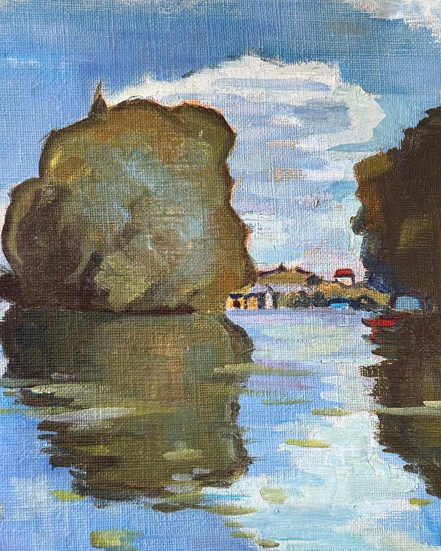 Framed oil on canvas depicting boats on the river Seine in Poissy, near Paris. Attributed to the style of Albert Marquet, a French painter. Signed Axier 1976. An impressionist painting with the use of bright blue and white colours used throughout the landscape, with small trees dotting the shoreline and fluffy clouds in a pale sky above.