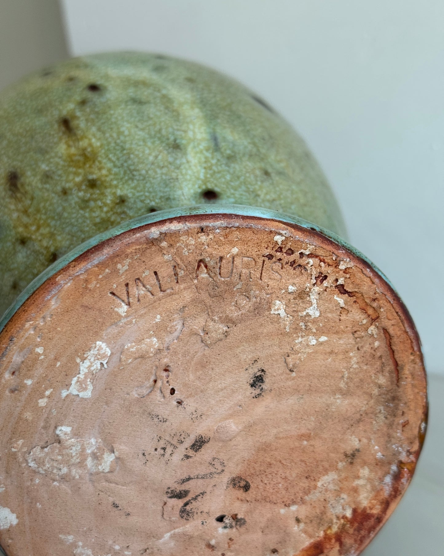 A large glazed ceramic vessel with a mottled two-tone green finish, made in South of France circa 19th Century. Signed Vallauris. The vessel features a large rounded handle on top, a smaller to the right and a small spout.